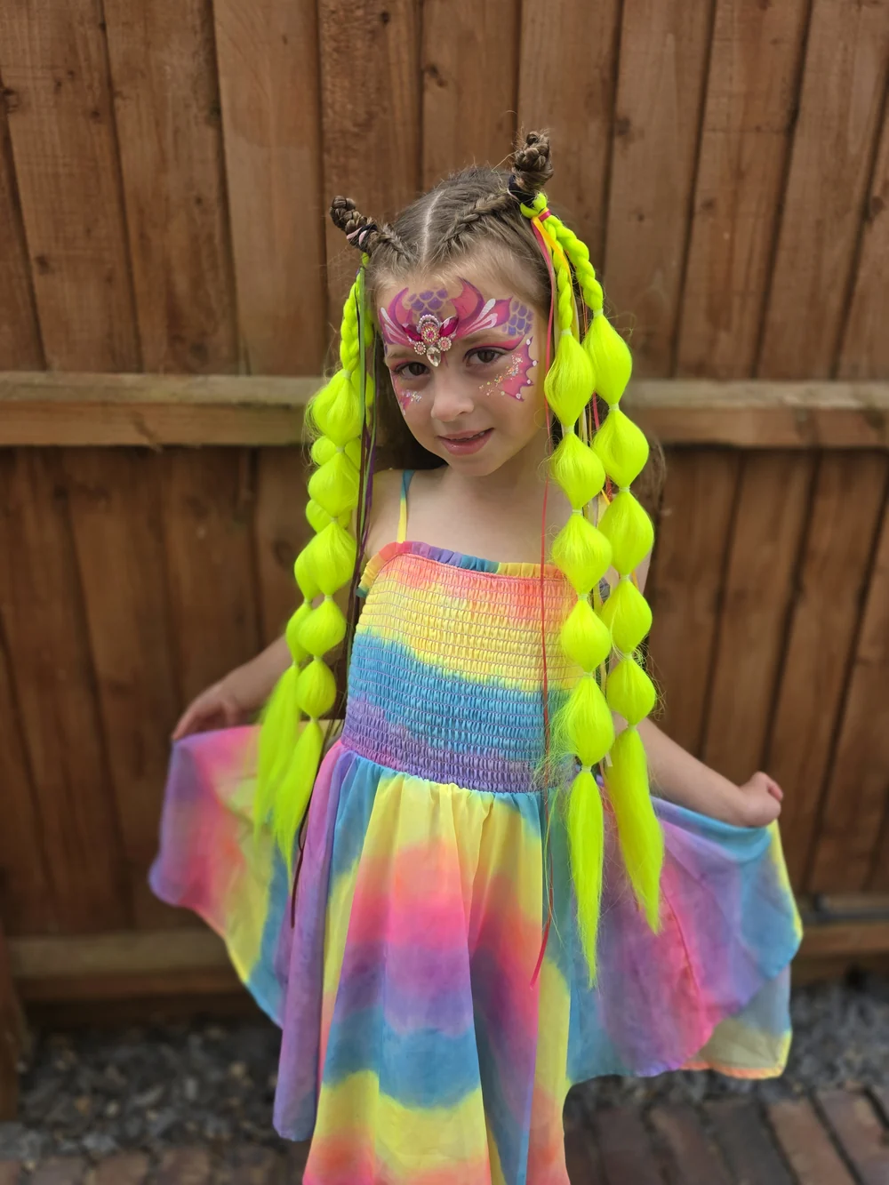 Long bright yellow braids worn with a colourful dress.