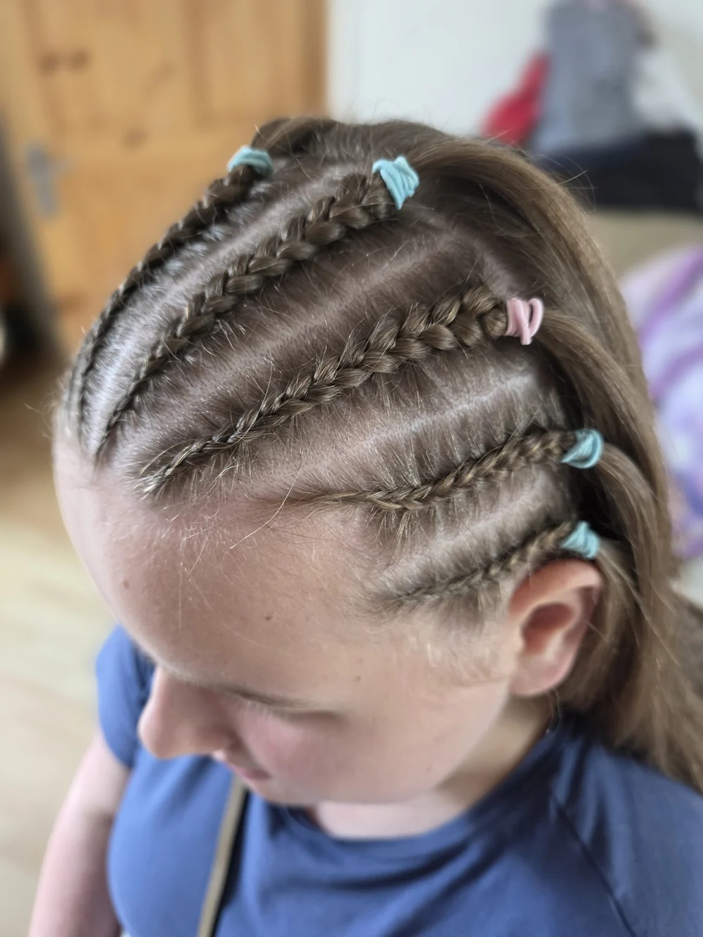 Close view of several cornrow braids and neatly divided sections.