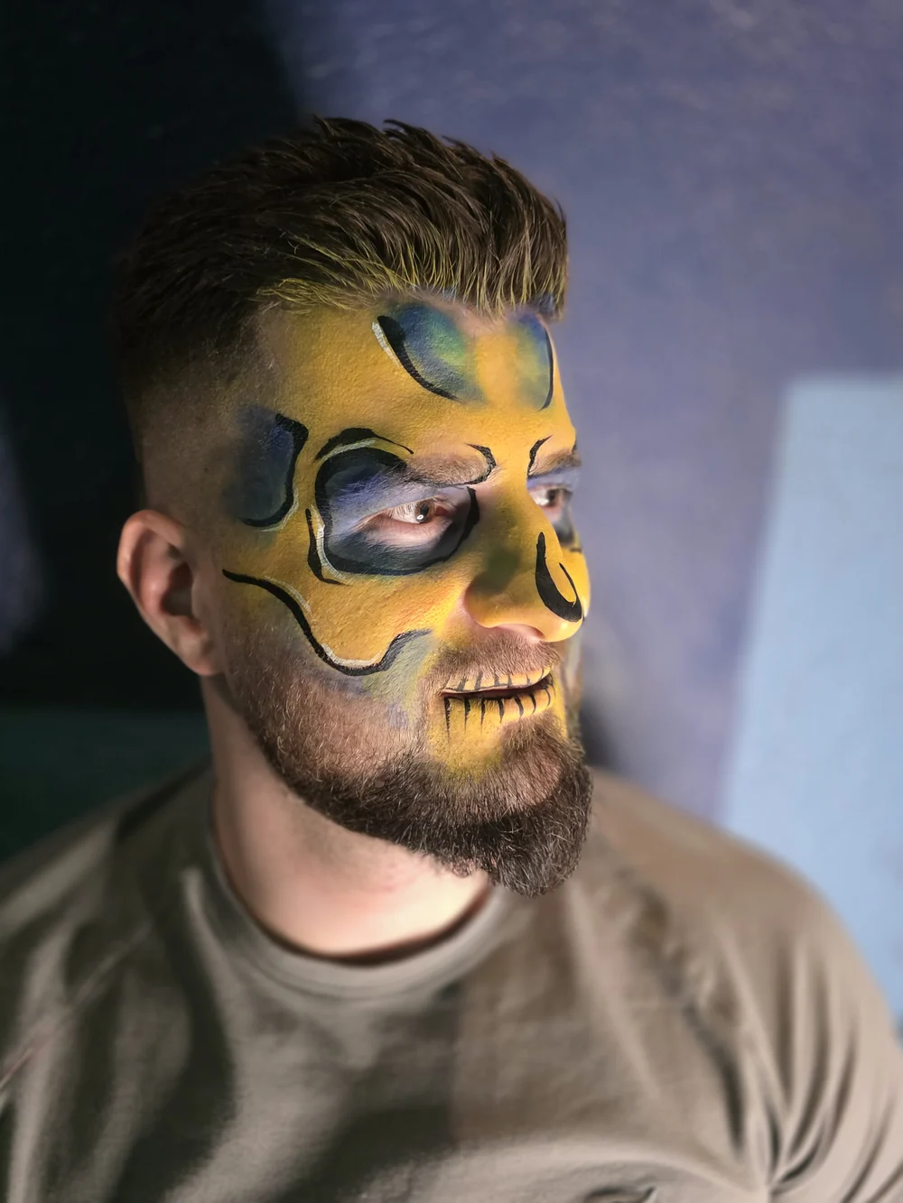Yellow and black skull face painting.