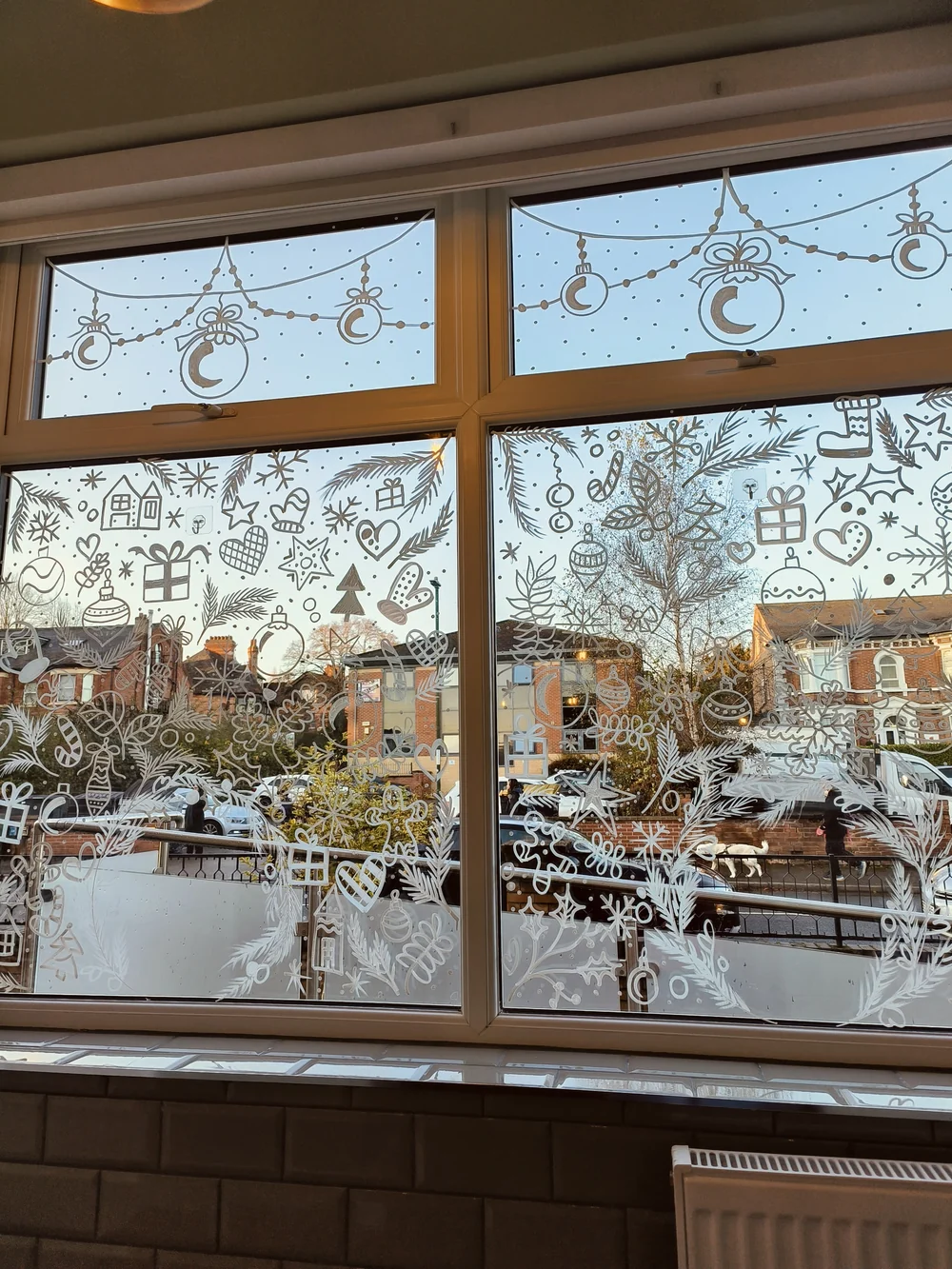White winter decorations painted across a shop window.